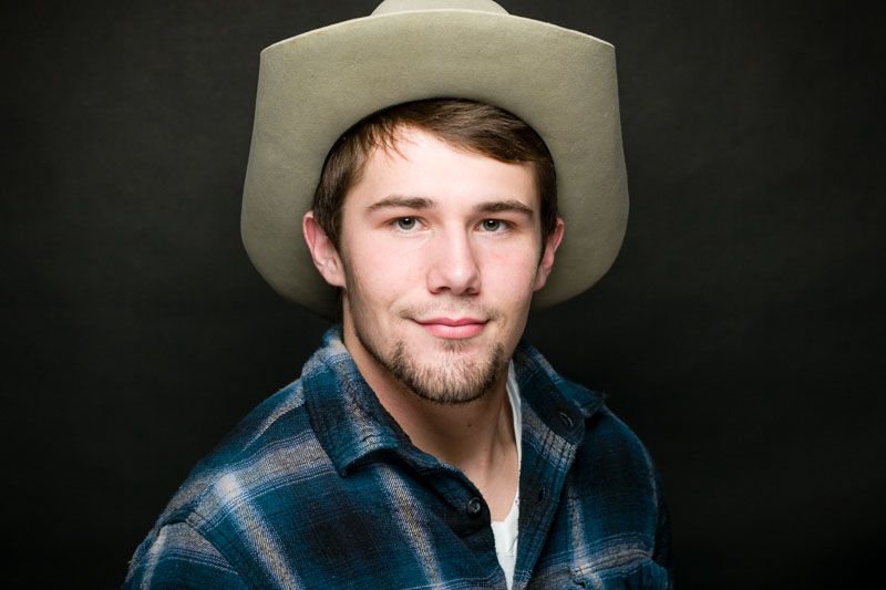 high school actor portrait as a cowboy in the musical Footloose